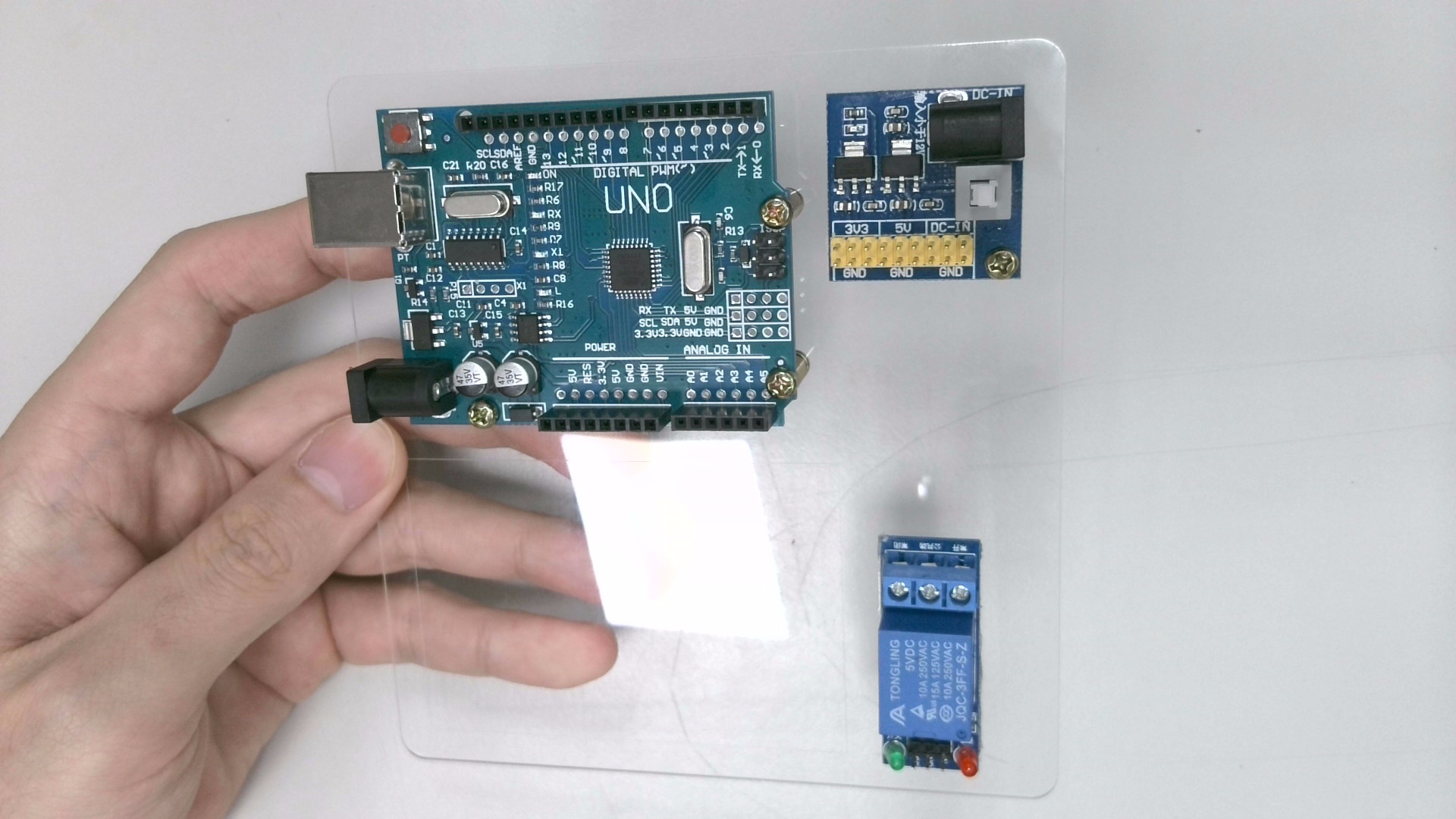 接著使用「泡綿膠」將「繼電器」黏貼在如下位置。拿取「M3螺絲 x1」、「M3螺母 x1」將「多路 DC 電源轉換模組」固定在如下位置。